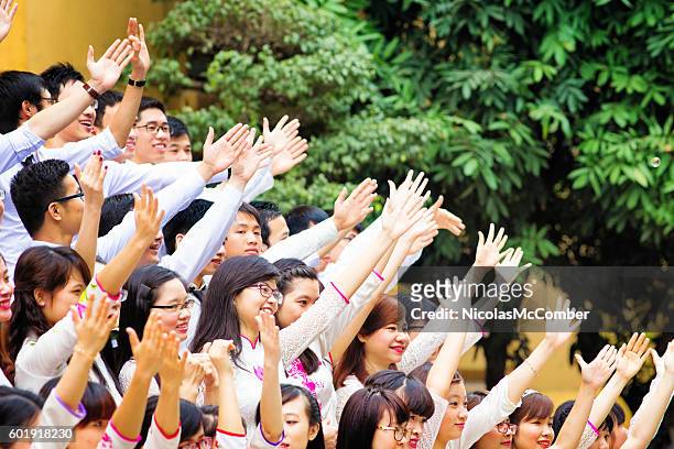 vietnamese students with hands up to celebrate graduation - vietnam school stock pictures, royalty-free photos & images