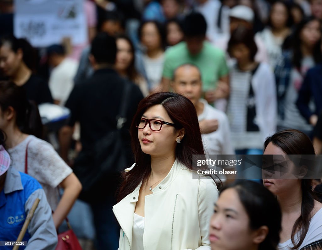 Asiatische Geschäftsfrau trägt Brille in der Menge