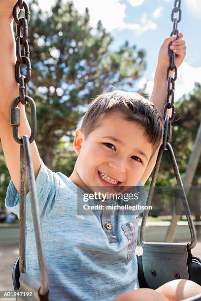 Little Boy At The Park On A Swing High-Res Stock Photo - Getty Images