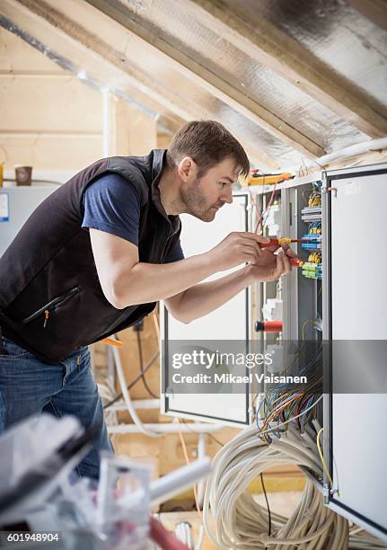 handyman constructing his own home - electrical fuse ストックフォトと画像
