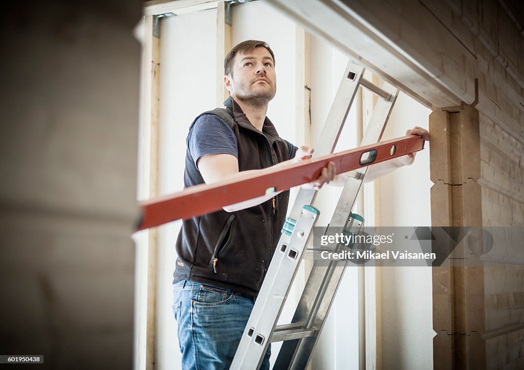 Handyman working on his own house