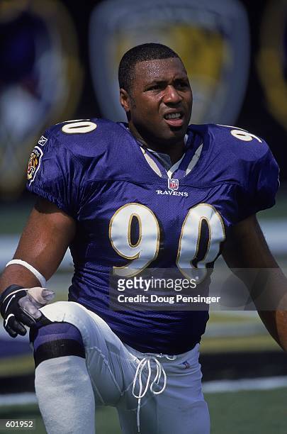 Rob Burnett of the Baltimore Ravens kneels and looks on during the game against the Chicago Bears at PSINET Stadium in Baltimore, Maryland. The...