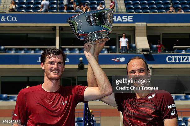 Jamie Murray of Great Britain and Bruno Soares of Brazil celebrate with the trophy after defeating Pablo Carreno Busta and Guillermo Garcia-Lopez of...