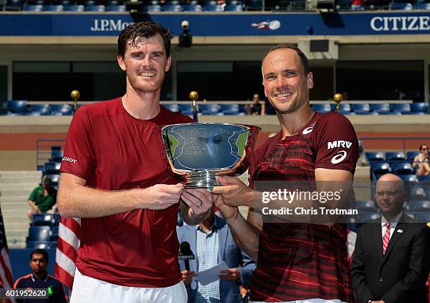 Jamie Murray of Great Britain and Bruno Soares of Brazil celebrate with the trophy after defeating Pablo Carreno Busta and Guillermo Garcia-Lopez of...