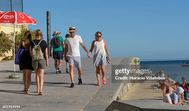 Visitors stroll by Praia da Duquesa on September 09, 2016 in Cascais, Portugal. Although active all year round, Portuguese tourist industry is having...