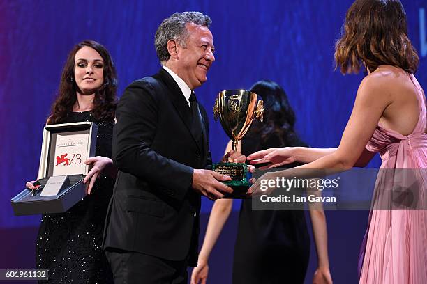 Jury member Gemma Arterton hands the award as a Jaeger-LeCoultre Unique Reverso watch is held to go along with as Paolo Del Brocco accepts the Coppa...