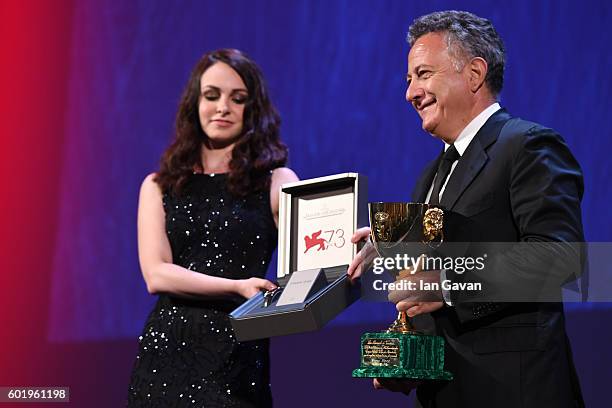 Jaeger-LeCoultre Unique Reverso watch is held to go along with as Paolo Del Brocco accepts the Coppa Volpi for Best Actress for Emma Stone for 'La La...