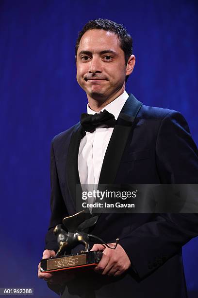 Juan de Dios Larrain poses with the Best Screenplay Award for 'Jackie' for Noah Oppenheim during the closing ceremony of the 73rd Venice Film...