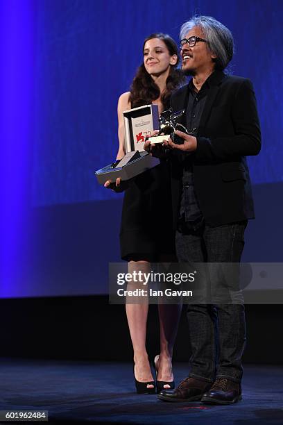 Director Lav Diaz is given a Jaeger-LeCoultre Unique Reverso engraved watch as he receives the Golden Lion for Best Film for 'The Woman who Left -...