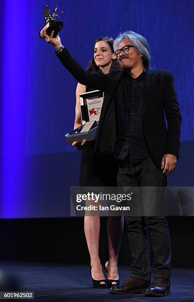 Director Lav Diaz is given a Jaeger-LeCoultre Unique Reverso engraved watch as he receives the Golden Lion for Best Film for 'The Woman who Left -...