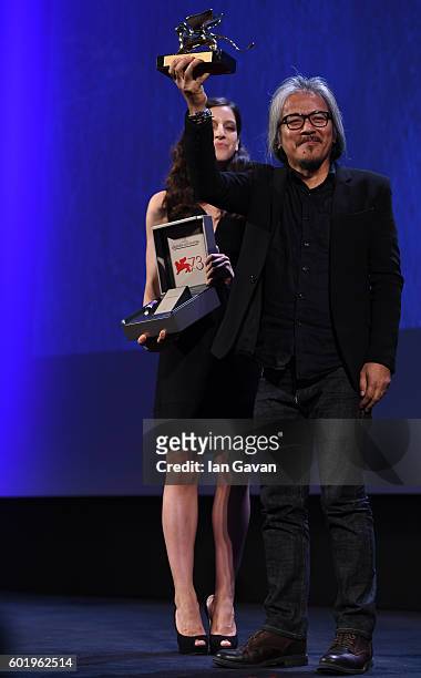 Director Lav Diaz is given a Jaeger-LeCoultre Unique Reverso engraved watch as he receives the Golden Lion for Best Film for 'The Woman who Left -...