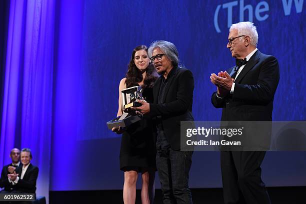 President of the festival Paolo Baratta looks on as Director Lav Diaz is given a Jaeger-LeCoultre Unique Reverso engraved watch and receives the...