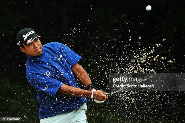 Hideki Matsuyama of Japan hits from a green side bunker on the fourth hole during the third round of the BMW Championship at Crooked Stick Golf Club...