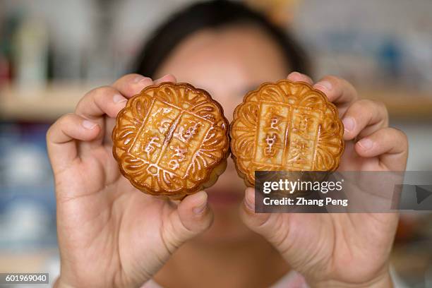 Girl holds mooncakes. On September 15, Chinese people will celebrate 2016 Mid-Autumn festival by getting together with their families and eating...