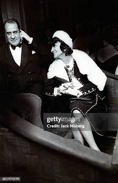 Herve Mille and Coco Chanel conversing with unseen figure at the Paris opening of Mouche.