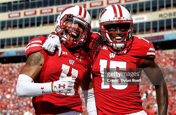 Jazz Peavy and Robert Wheelwright of the Wisconsin Badgers celebrate after Peavy scored a touchdown in the second quarter against the Akron Zips at...