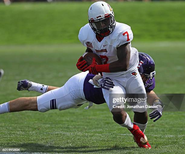 George Moreira of the Illinois State Redbirds breaks away from Jaylen Prater of the Northwestern Wildcats at Ryan Field on September 10, 2016 in...