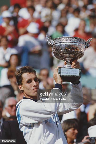 Ivan Lendl of Czechoslovakia holds the trophy aloft after defeating Mikael Pernfors during the Men's Singles Final match at the French Open Tennis...