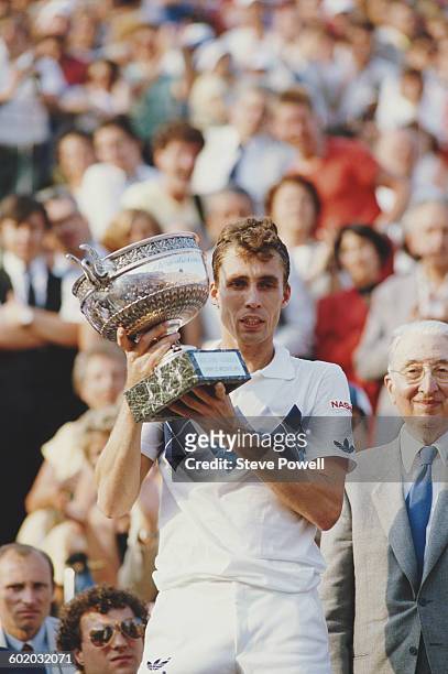 Ivan Lendl of Czechoslovakia holds the trophy after defeating John McEnroe during the Men's Singles Final match at the French Open Tennis...