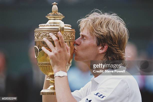 Stefan Edberg of Sweden kisses trophy as he celebrates defeating Boris Becker in the Men's Singles Final of the Wimbledon Lawn Tennis Championship on...