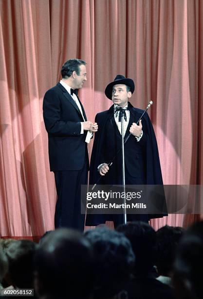 Comedians, writers and directors Carl Reiner and Mel Brooks perform their routine 'The 2000 Year Old Man' circa 1967 in Los Angeles, California.