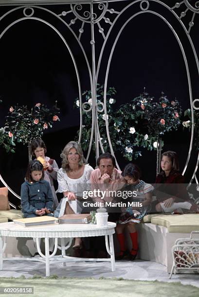 Musician Paul Anka and his wife Anne de Zogheb sit with four of their daughters during a photo shoot circa 1970's.