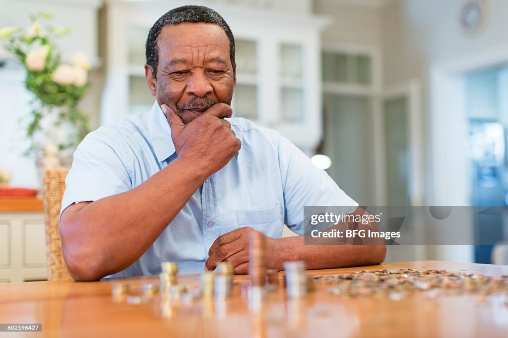 Senior man counting coins, Cape Town, South Africa