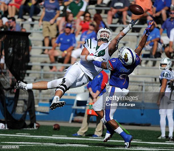 Troy Mangen of the Ohio Bobcats goes up for a pass against Fish Smithson of the Kansas Jayhawks in the third quarter at Memorial Stadium on September...