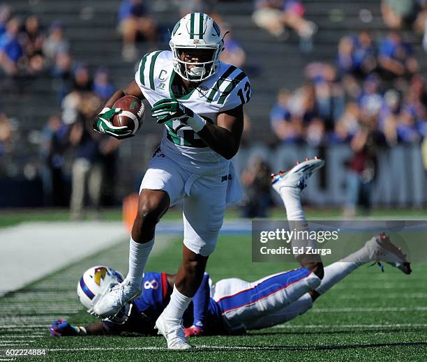 Jordan Reid of the Ohio Bobcats gets past cornerback Brandon Stewart of the Kansas Jayhawks as he looks to pick up extra yards in the third quarter...