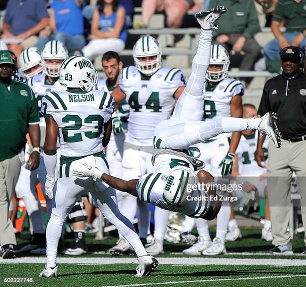 Mayne Williams of the Ohio Bobcats flips over Kylan Nelson after intercepting a pass against the Kansas Jayhawks in the fourth quarter at Memorial...