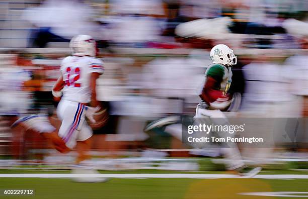 Tony Nicholson of the Baylor Bears returns a punt against RC Cox of the Southern Methodist Mustangs in the seconf half at McLane Stadium on September...