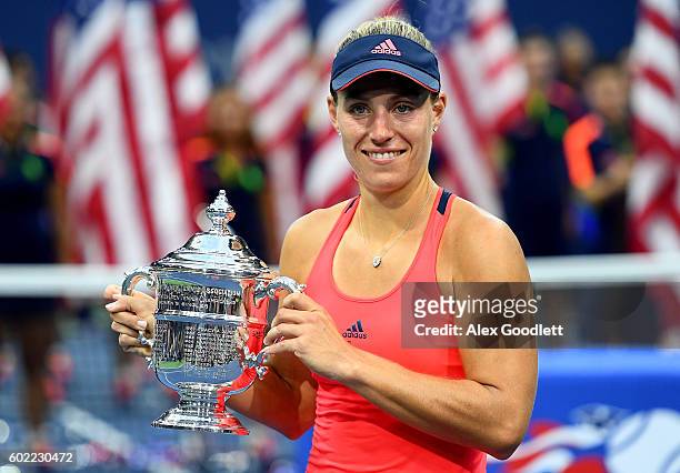 Angelique Kerber of Germany celebrates with the trophy after winning , , against Karolina Pliskova of the Czech Republic during their Women's Singles...