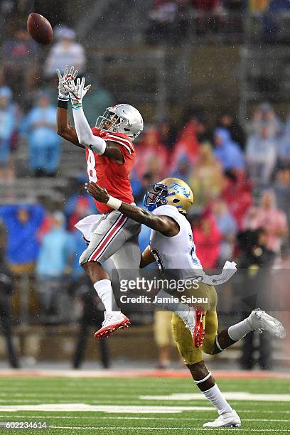 Gareon Conley of the Ohio State Buckeyes intercepts a pass intended for Justin Hobbs of the Tulsa Hurricane in the third quarter at Ohio Stadium on...