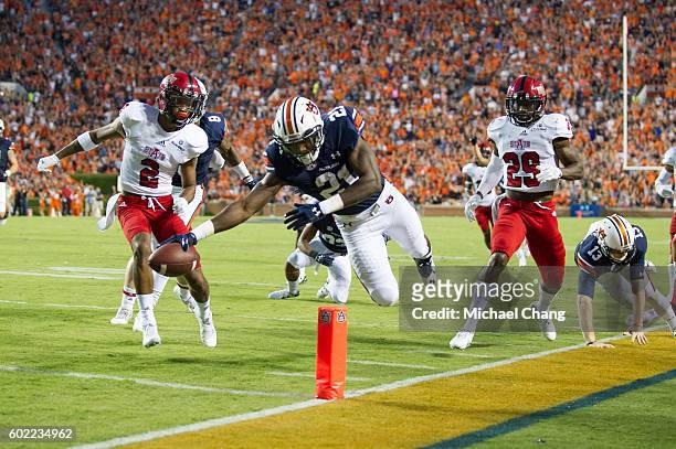 Running back Kerryon Johnson of the Auburn Tigers dives into the end zone for a touchdown during their game against the Arkansas State Red Wolves at...