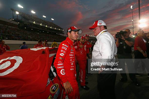 Kyle Larson, driver of the Target Chevrolet, talks with team owner Chip Ganassi prior to the NASCAR Sprint Cup Series Federated Auto Parts 400 at...