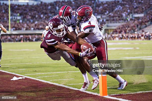 Gabe Myles of the Mississippi State Bulldogs reaches out with the ball but does not score while being pushed out of bounds by Bryson Allen-Williams...