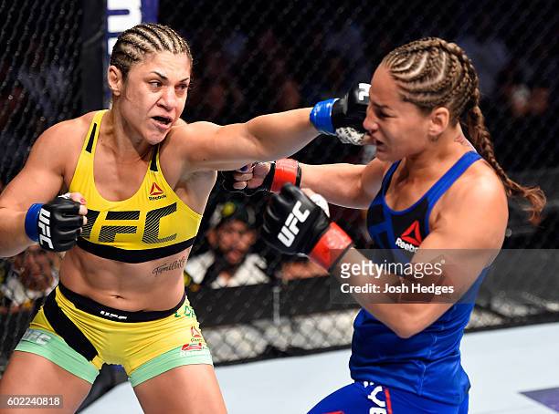 Bethe Correia of Brazil punches Jessica Eye in their women's bantamweight bout during the UFC 203 event at Quicken Loans Arena on September 10, 2016...