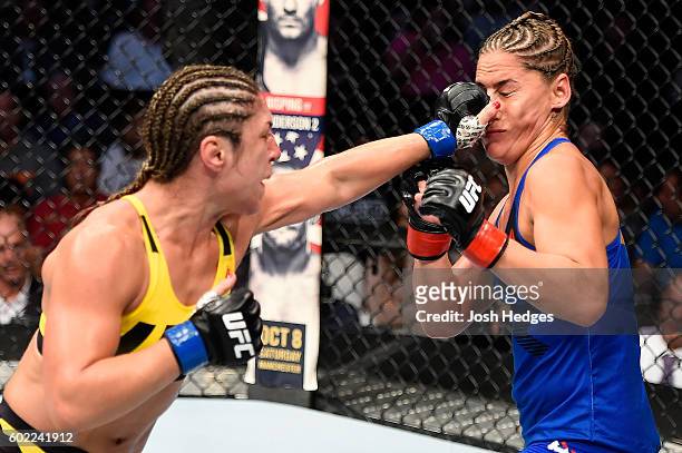 Bethe Correia of Brazil punches Jessica Eye in their women's bantamweight bout during the UFC 203 event at Quicken Loans Arena on September 10, 2016...