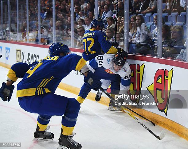 Patric Hornqvist of Sweden is challenged by Mikael Graulund of Finland during the World Cup of Hockey game between Finland and Sweden at the Hartwell...