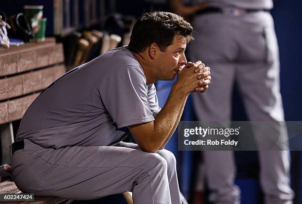 Rich Hill of the Los Angeles Dodgers looks on from the dugout after being pulled during the eighth inning despite pitching seven perfect innings...