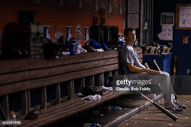 Rich Hill of the Los Angeles Dodgers looks on from the dugout after being pulled during the eighth inning despite pitching seven perfect innings...