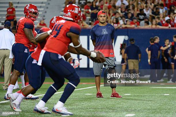 Quarterback Anu Solomon of the Arizona Wildcats watches as his teammates warmup on the field prior to the game against the Grambling State Tigers at...
