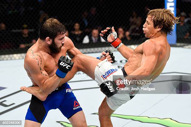 Urijah Faber kicks the torso of Jimmie Rivera in their bantamweight bout during the UFC 203 event at Quicken Loans Arena on September 10, 2016 in...