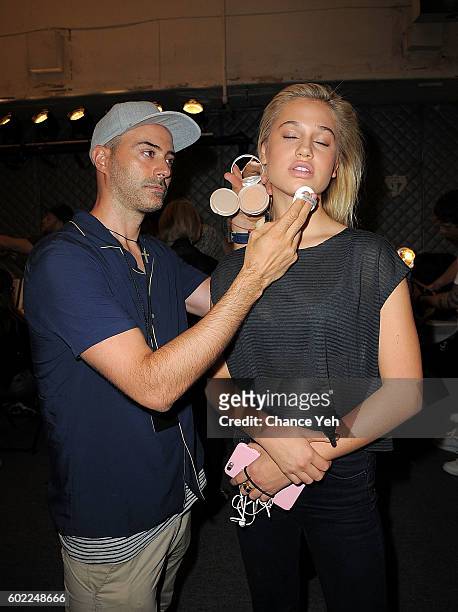 Gato prepares the makeup of model Meredith Mickelson backstage at the Jonathan Simkhai show during September 2016 MADE Fashion Week at The Arc,...