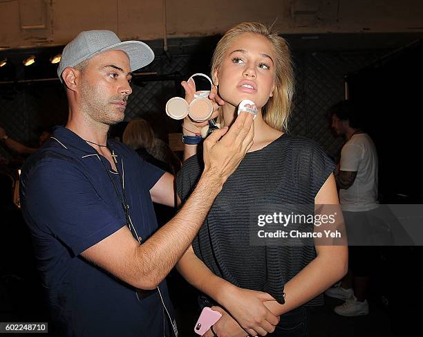 Gato prepares the makeup of model Meredith Mickelson backstage at the Jonathan Simkhai show during September 2016 MADE Fashion Week at The Arc,...