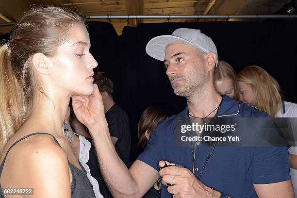 Gato prepares the makeup of a model backstage at the Jonathan Simkhai show during September 2016 MADE Fashion Week at The Arc, Skylight at Moynihan...