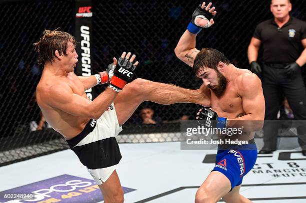 Urijah Faber kicks Jimmie Rivera in their bantamweight bout during the UFC 203 event at Quicken Loans Arena on September 10, 2016 in Cleveland, Ohio.