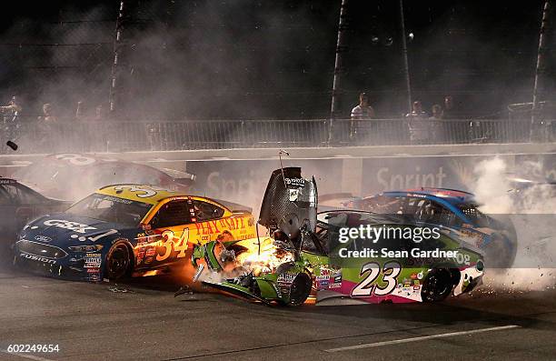 Chris Buescher, driver of the CSX - Play it Safe Ford, and David Ragan, driver of the sweetFrog Toyota, are involved in an on-track incident during...