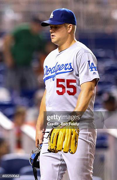 Joe Blanton of the Los Angeles Dodgers walks off the field after giving up a hit during the eighth inning to break up the combined no-no bid against...