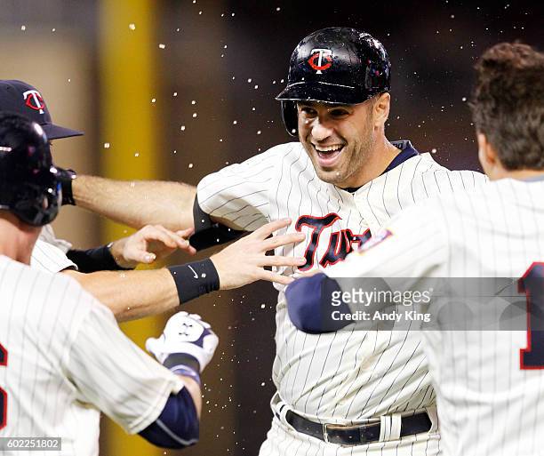 Minnesota Twins Joe Mauer celebrates with teammates after Mauer hit a walk-off single to beat Cleveland Indians 2-1 in a twelve inning game at Target...